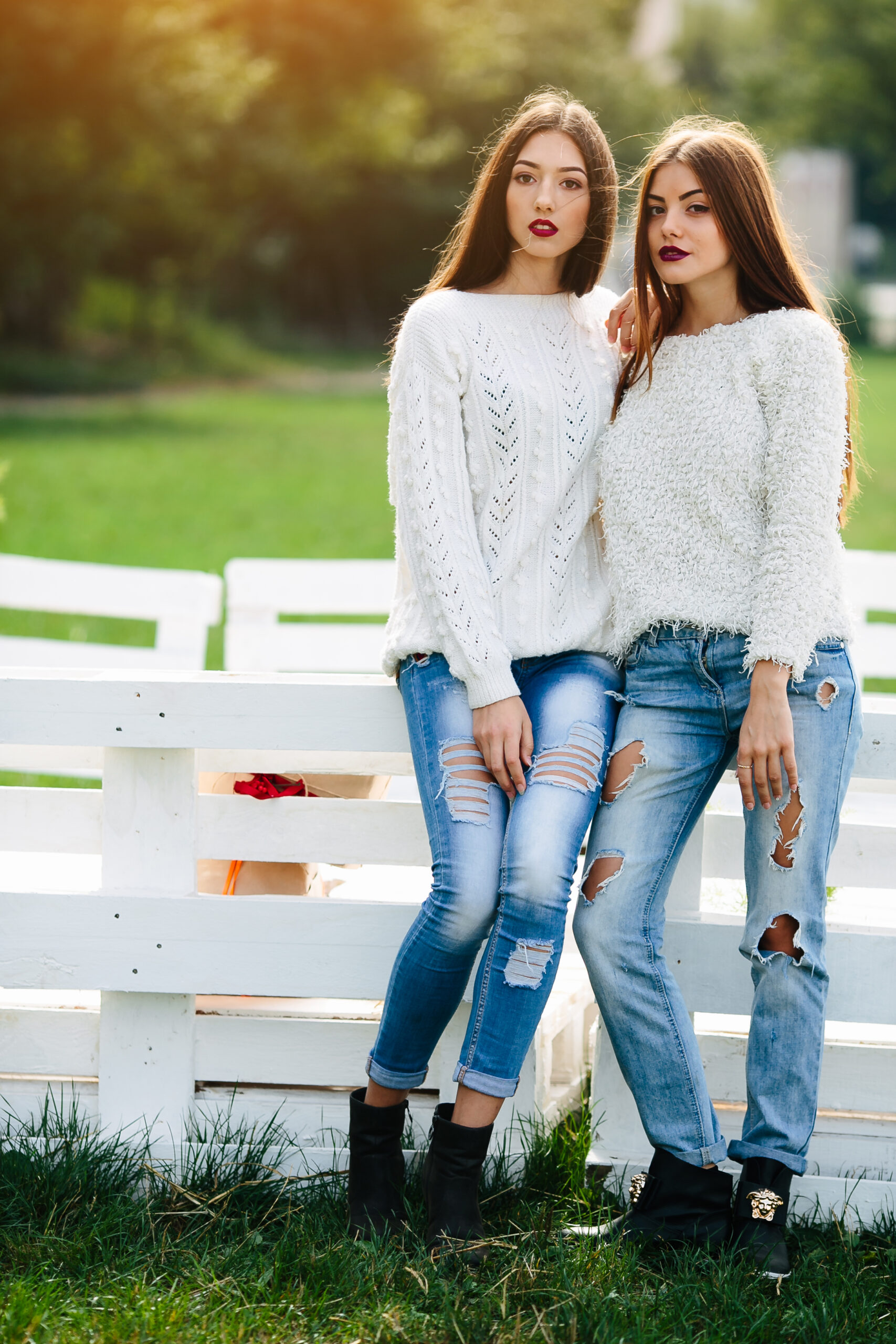 Two girls lean bench